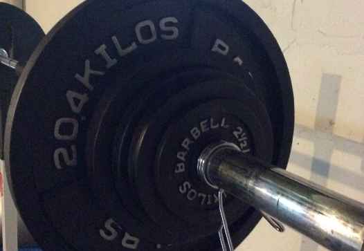 A close up of a barbell with a weight on it